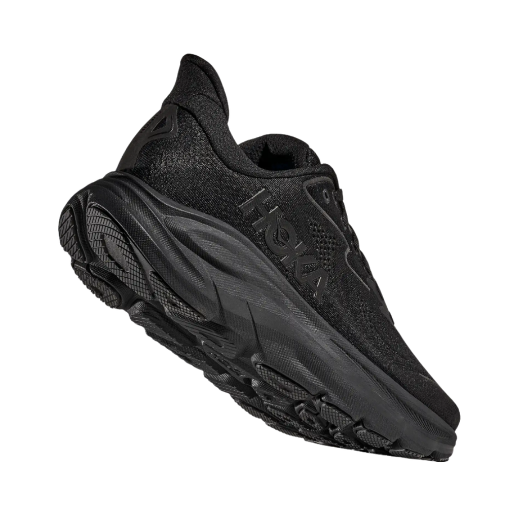Bottom heel view of the HOKA Men’s Clifton 10 in Black/Black, highlighting the durable outsole with traction zones designed for reliable grip and long-lasting performance.